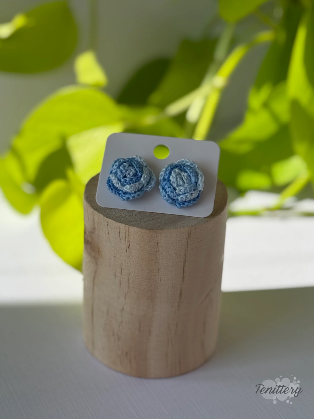 Háčkované náušnice ve tvaru růžiček, o velikosti 18 mm s puzetami z chirurgické oceli v ombré světle modrých odstínech.
