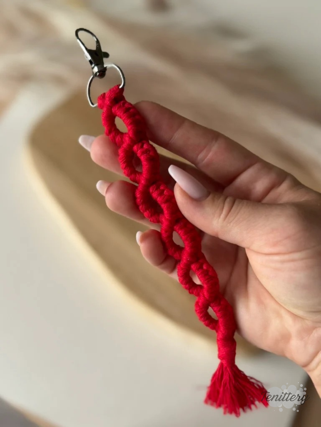 Macramé klíčenka Infinity Long v červené barvě - v ruce.