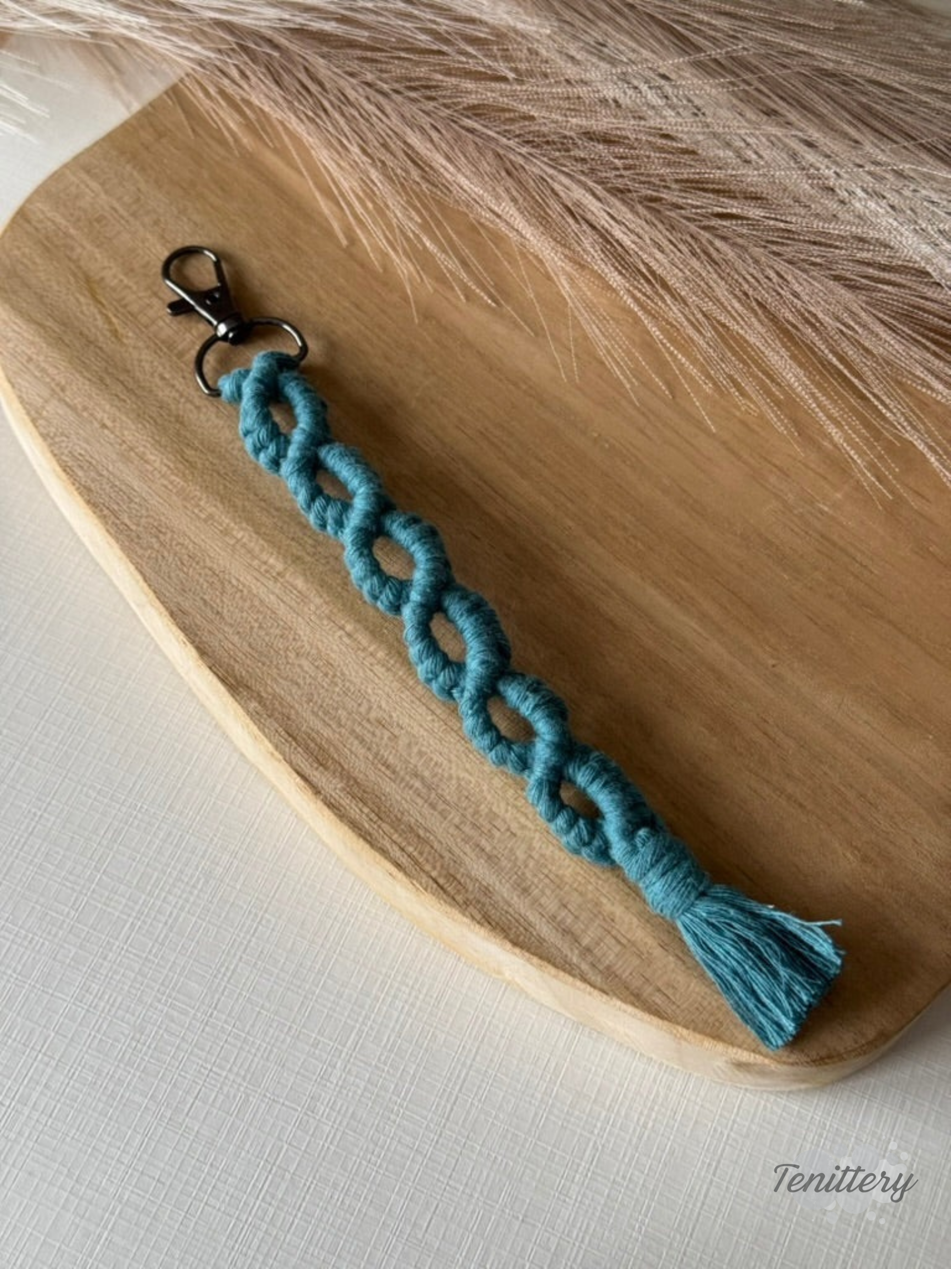Macramé klíčenka Infinity Long v petrolejové barvě.
